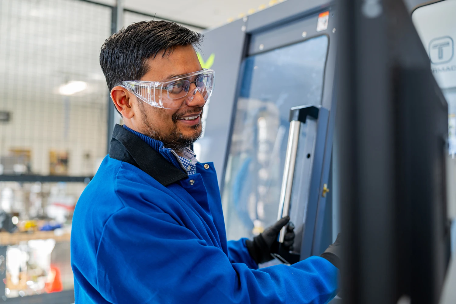 Man in safety glasses working with machinery