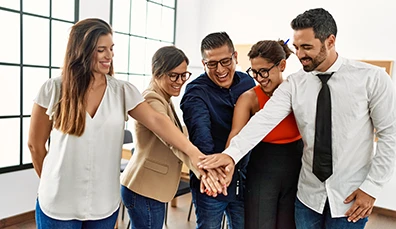 Latin American business people with their hands in on each other