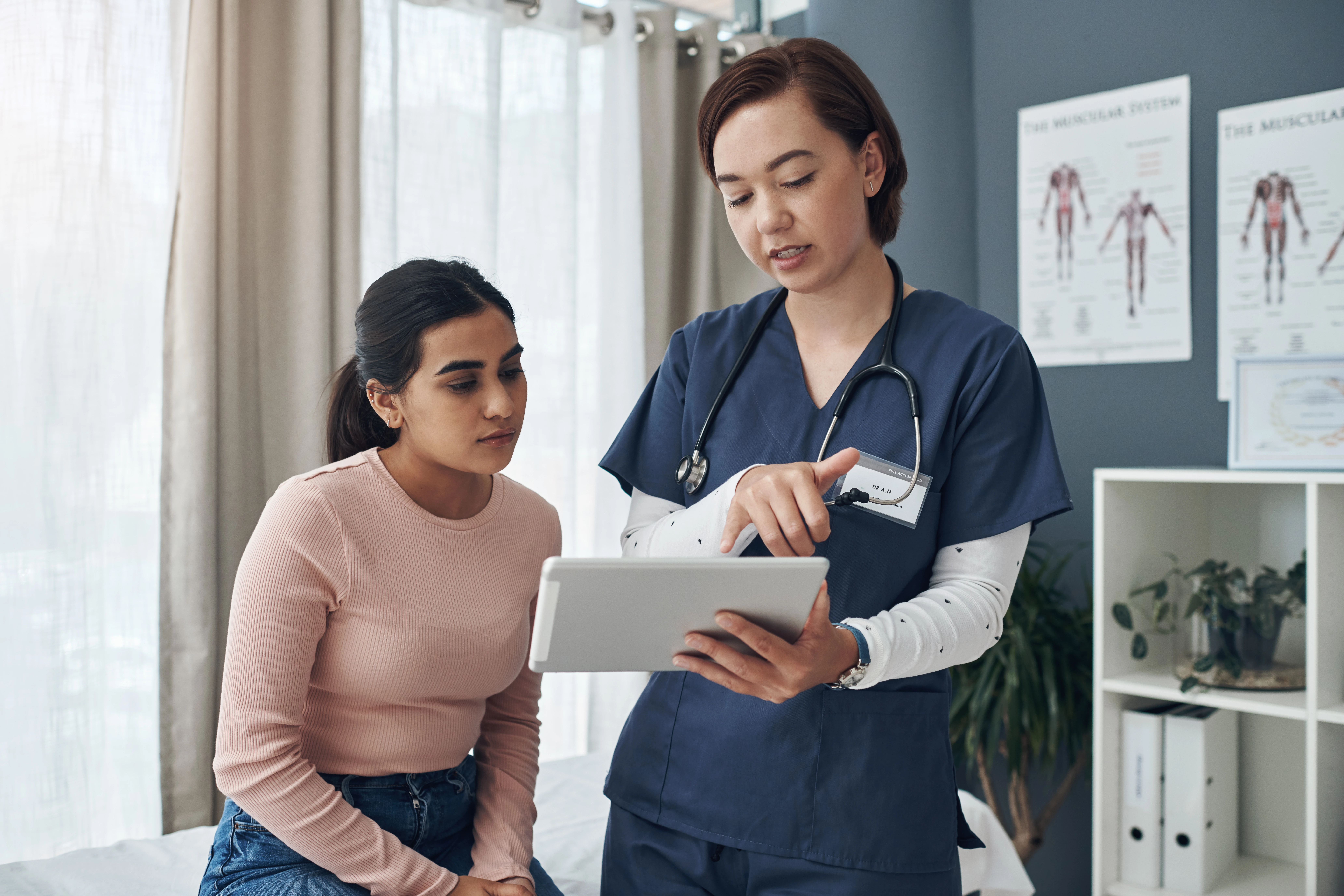 Medical personnel going over a document with a patient.