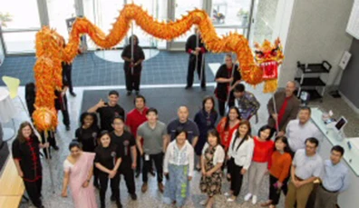 Asian American business people posing in a lobby