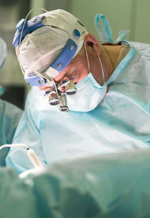 Doctor in surgery wearing magnifying lenses