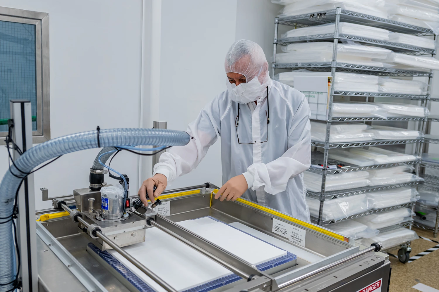 Man in sterile gear working on machine