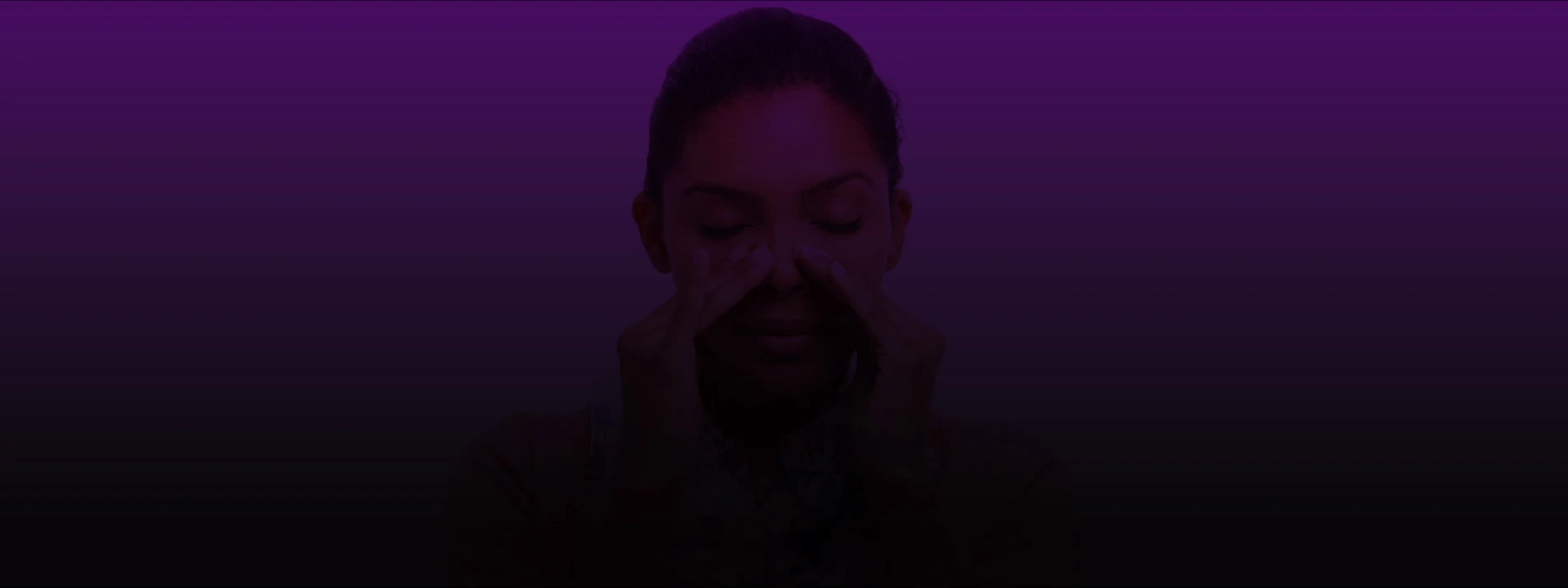 Woman holding her nose with both hands in discomfort