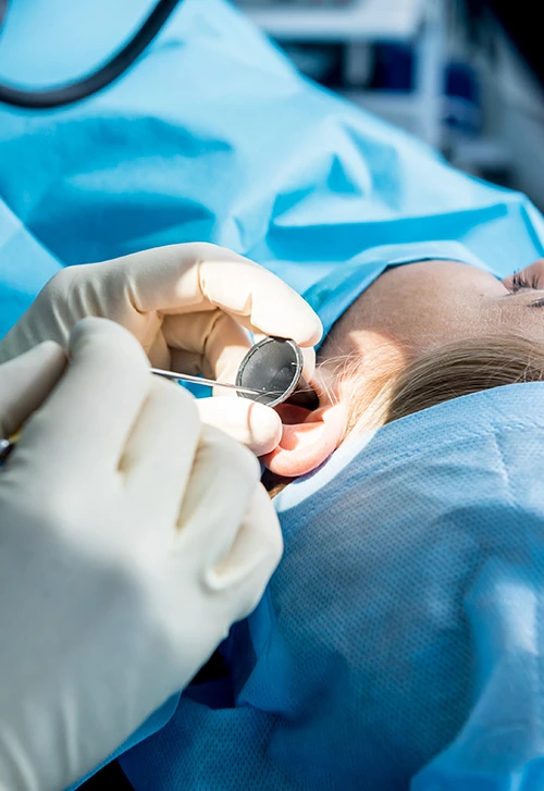 Doctor performing a procedure on a patient's ear