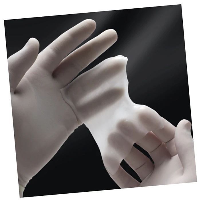 Gloved hands holding up substitute dura mater