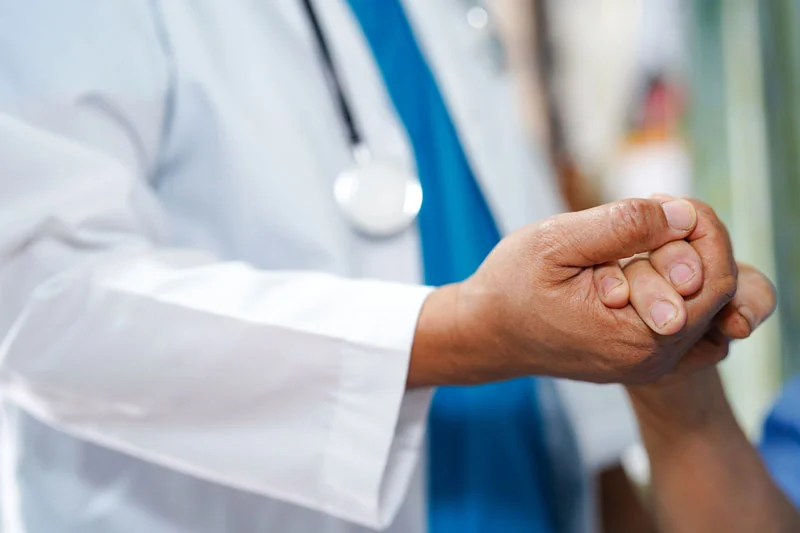 Doctor holding a patient's hand