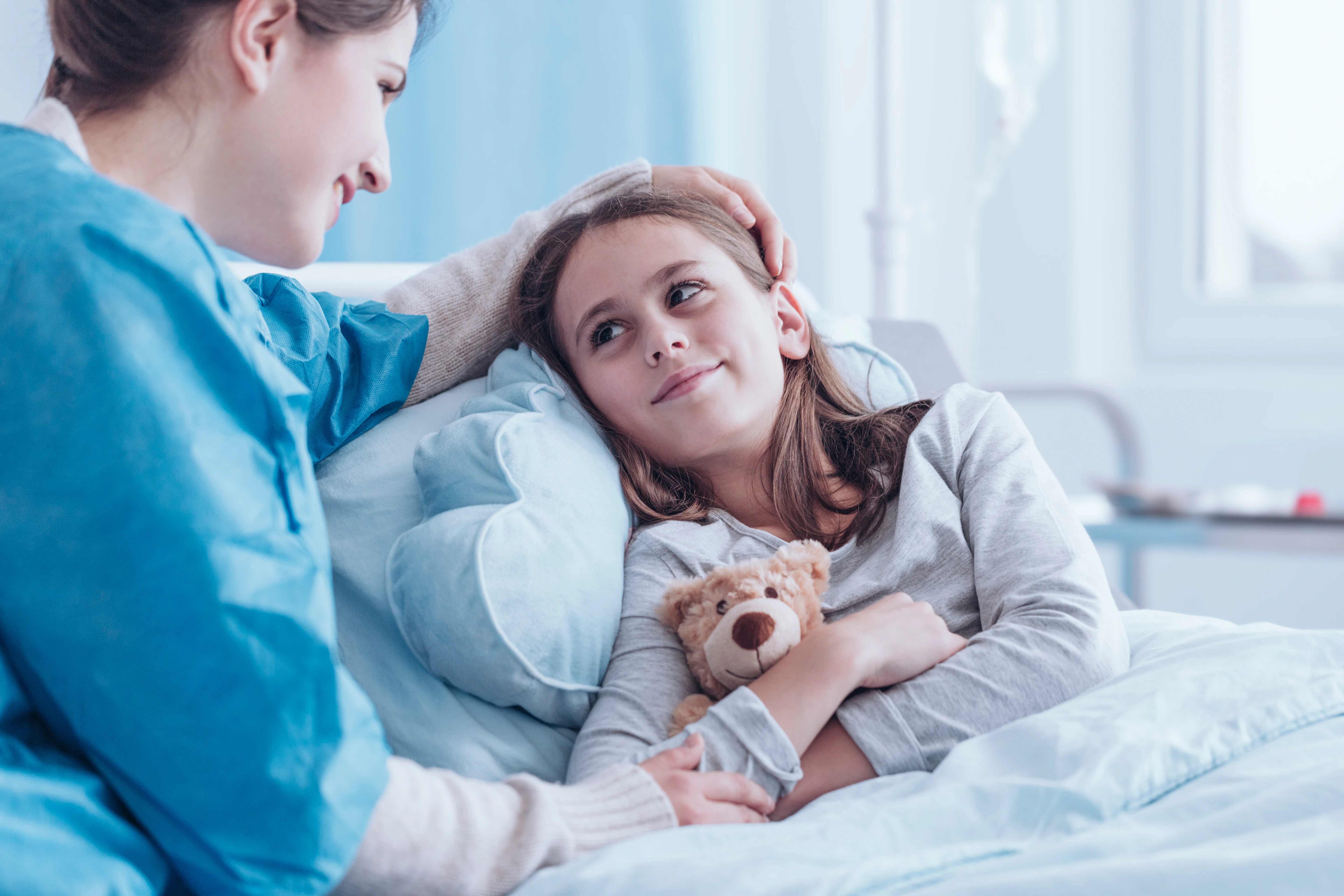 Mother at bed side of child in hospital.