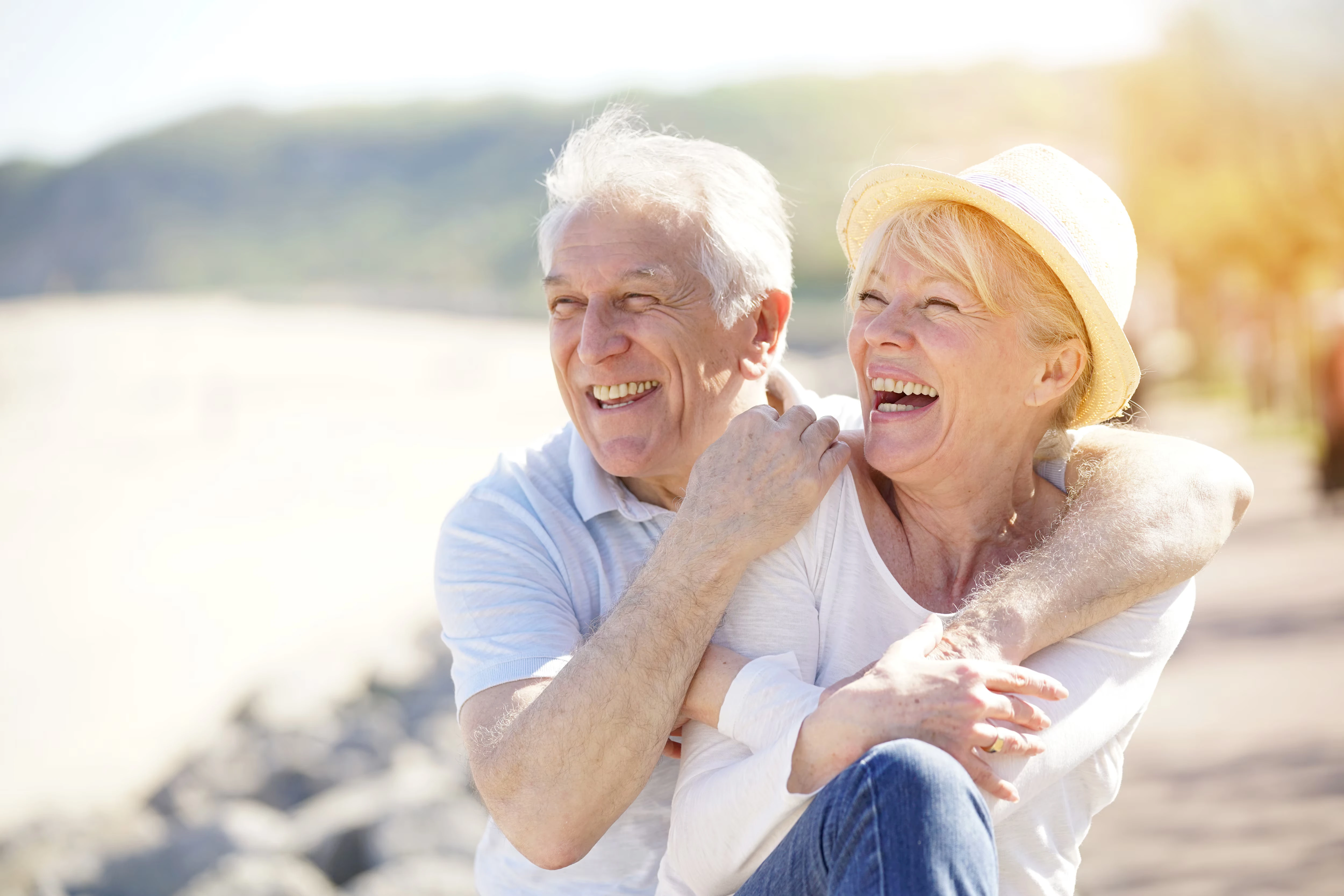 An embracing older couple smiling. 