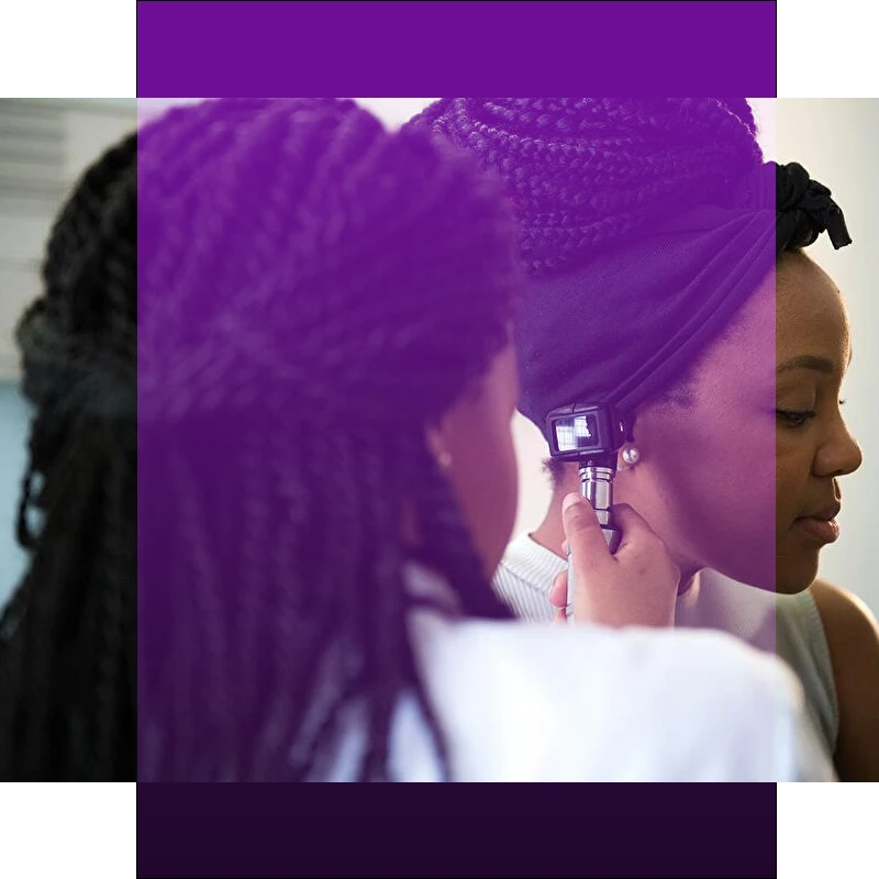 Doctor using otoscope on patient